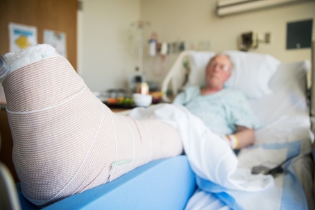 man in hospital with cast on leg